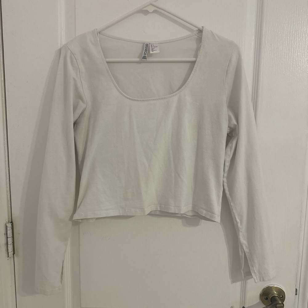 White long sleeve top, sleeves flare at the end